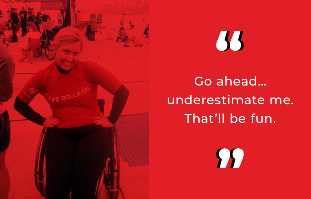 Red and black graphic of Amber OHaver. Next to a quote. Go ahead, underestimate me. That'll be fun. She smiles with her hands on her hips. Wearing a Life Rolls On shirt while in her wheelchair.